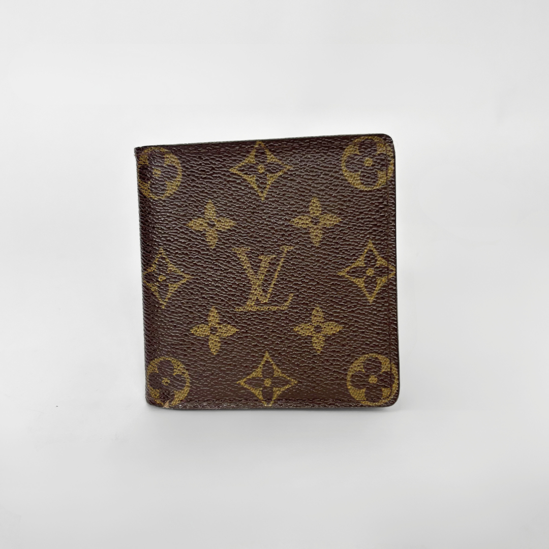 Louis Vuitton wallet with monogram pattern on a white background