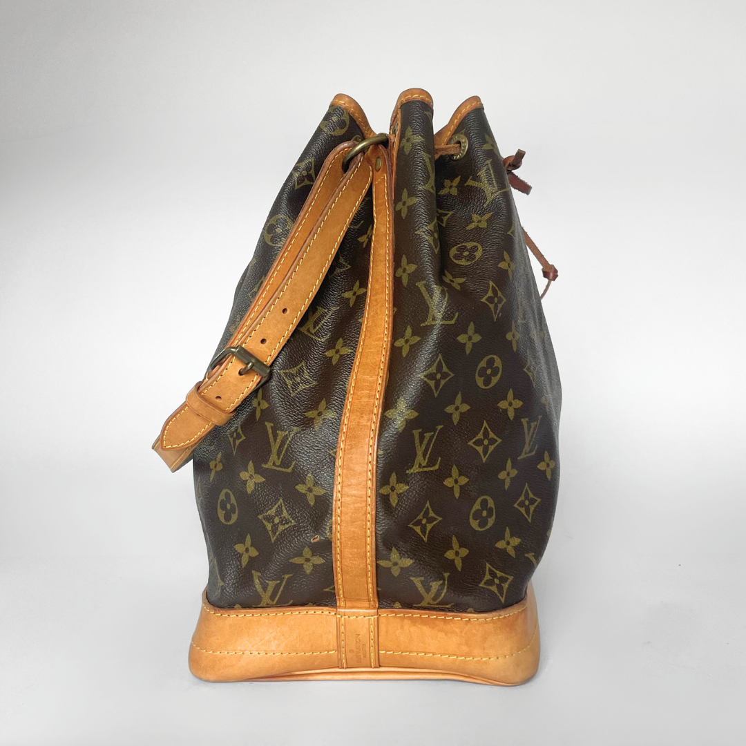 Designer handbag with monogram pattern on a white background