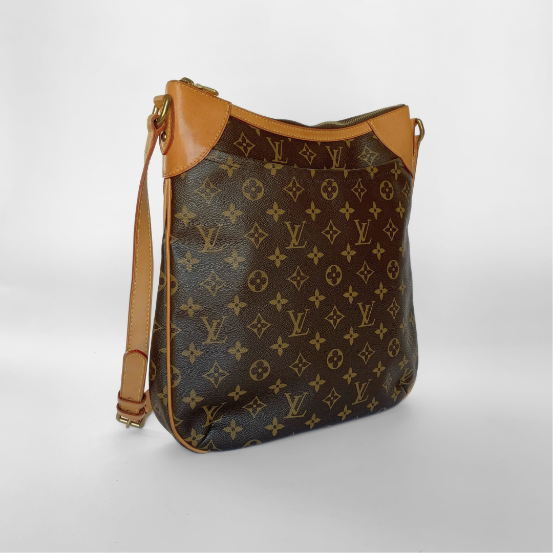 Designer handbag with monogram pattern on a light gray background