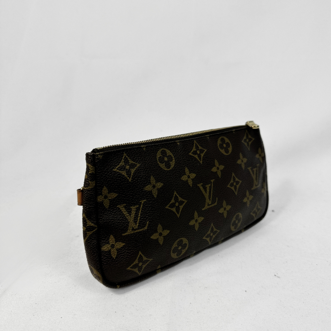 A Louis Vuitton monogram canvas pouch in dark brown with gold-tone zippers, photographed on a light gray background.