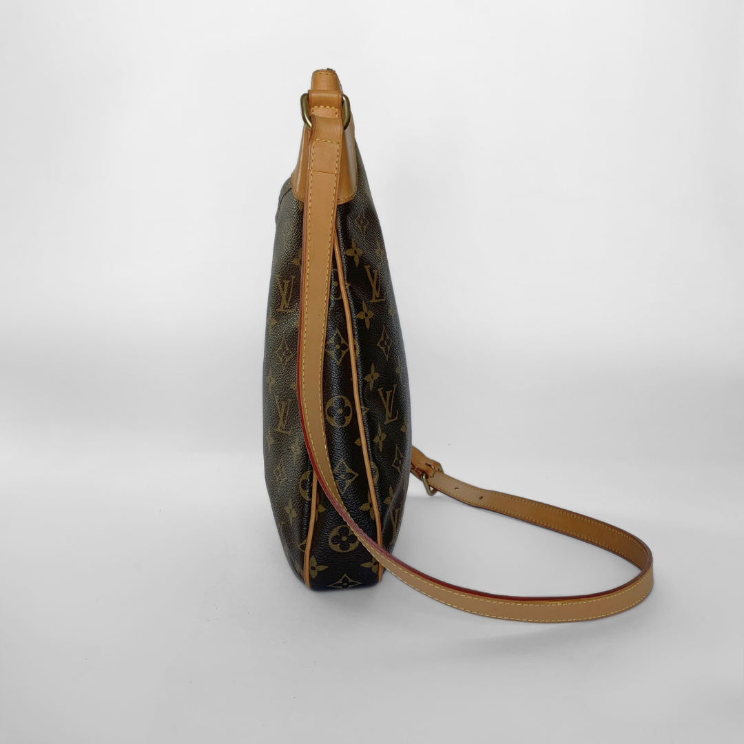 Designer handbag with monogram pattern on a light gray background