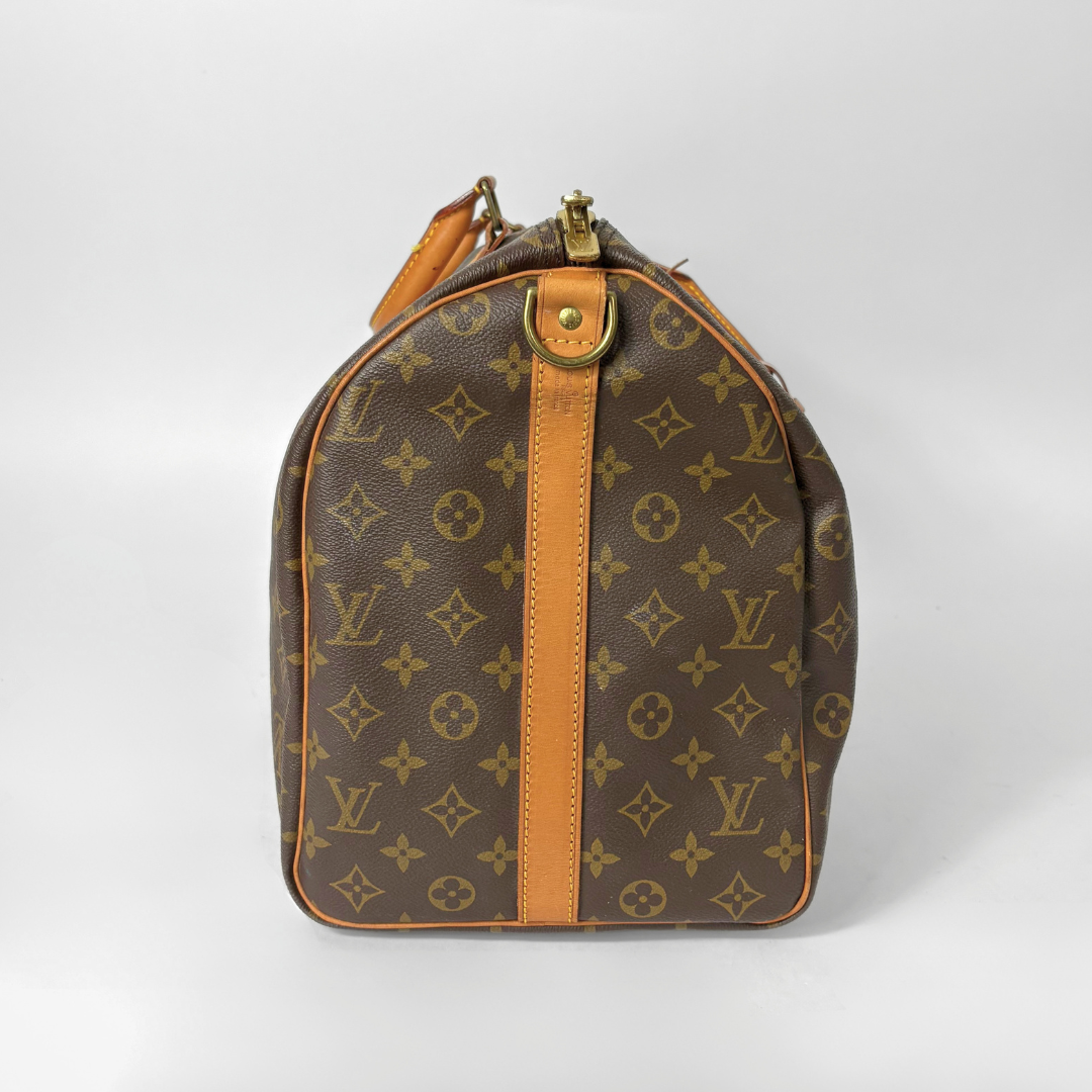 Brown Louis Vuitton bag with monogram pattern on a white background