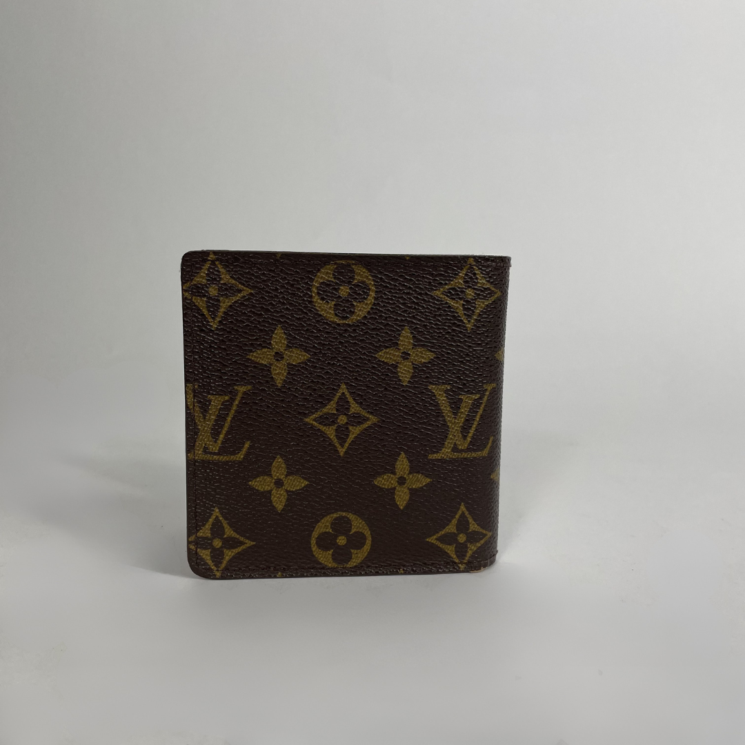 A brown monogram wallet with gold-tone Louis Vuitton logos and floral motifs, standing upright on a light gray background.