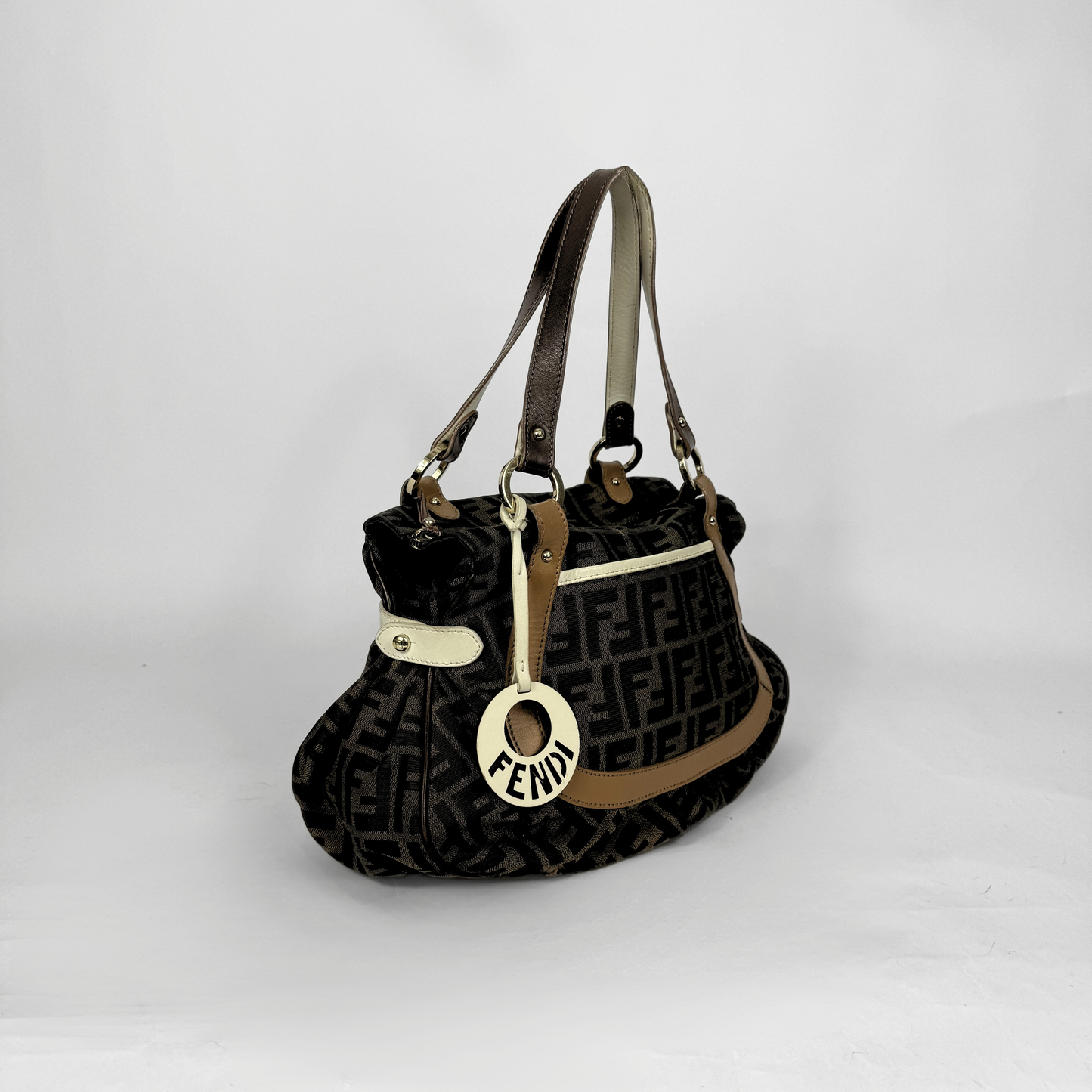 Fendi Zucca monogram canvas shoulder bag with letaher trim and a large white cicular FENDI charm.