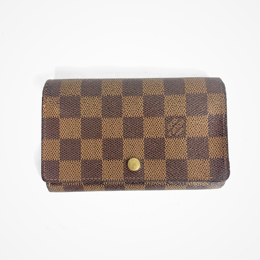Brown checkered LV wallet with gold accents on a white background