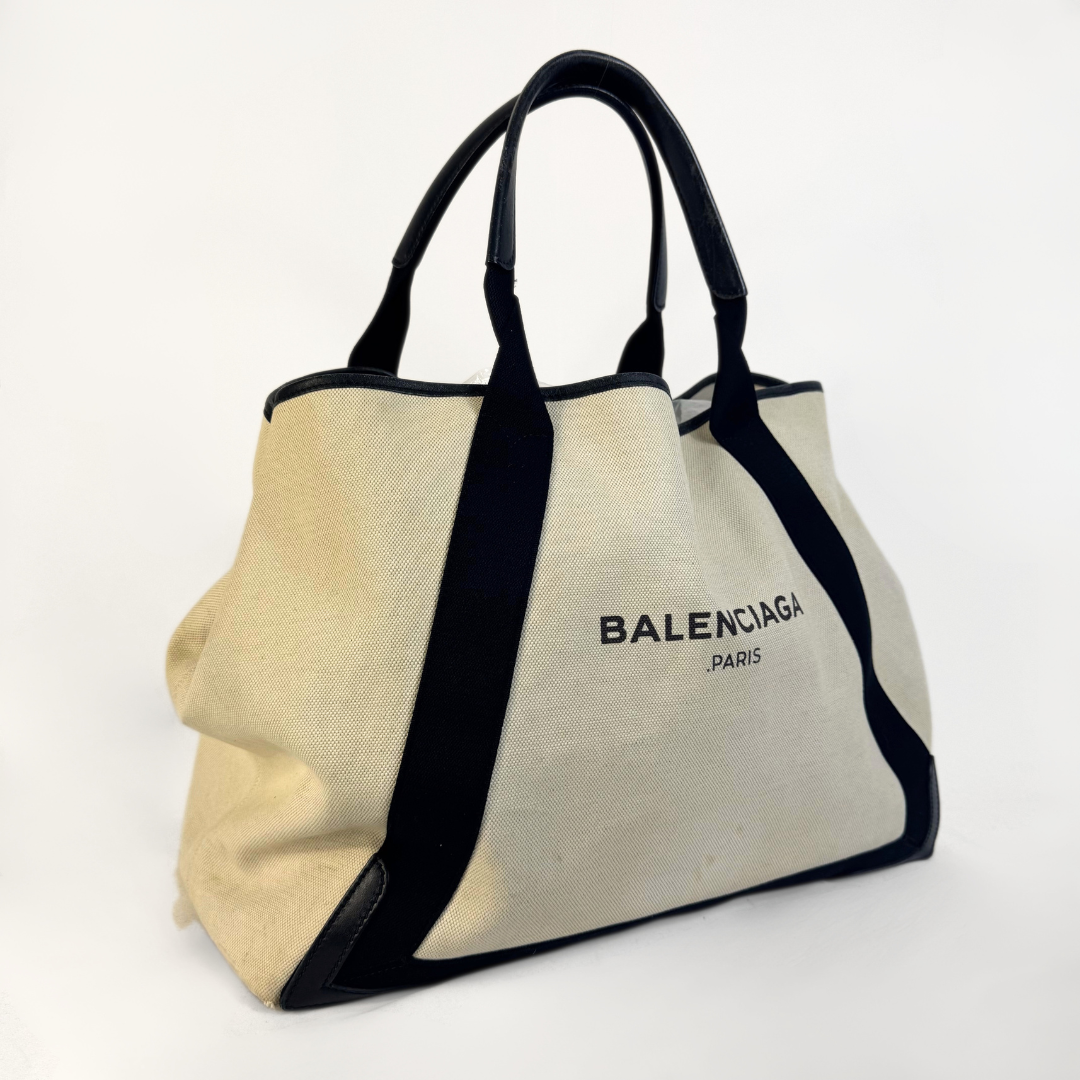 Balenciaga tote bag with black accents on a light gray background