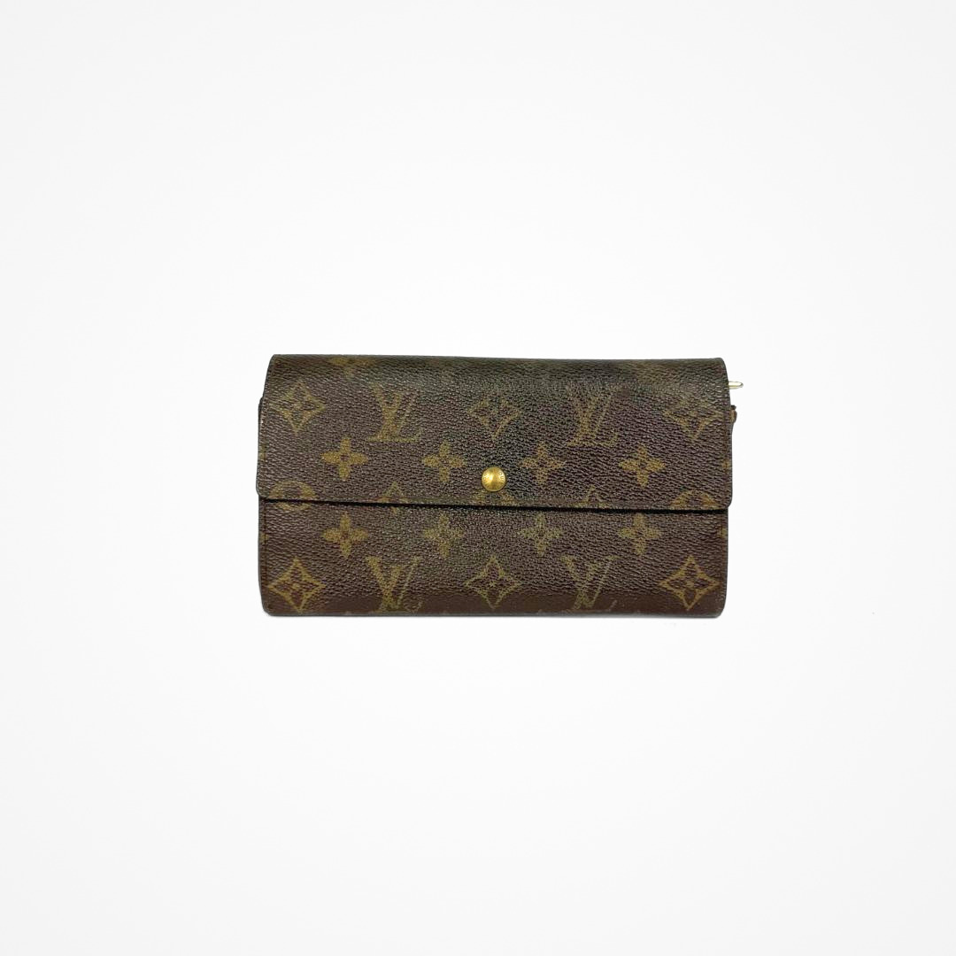 Louis Vuitton Wallet Large with gold monogram pattern on a white background