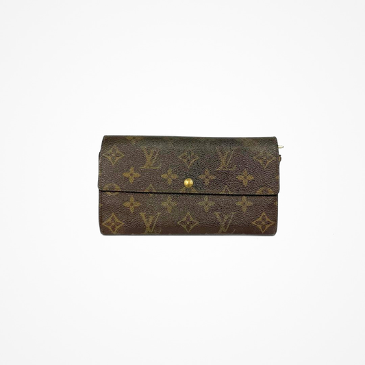 Louis Vuitton Wallet Large with gold monogram pattern on a white background