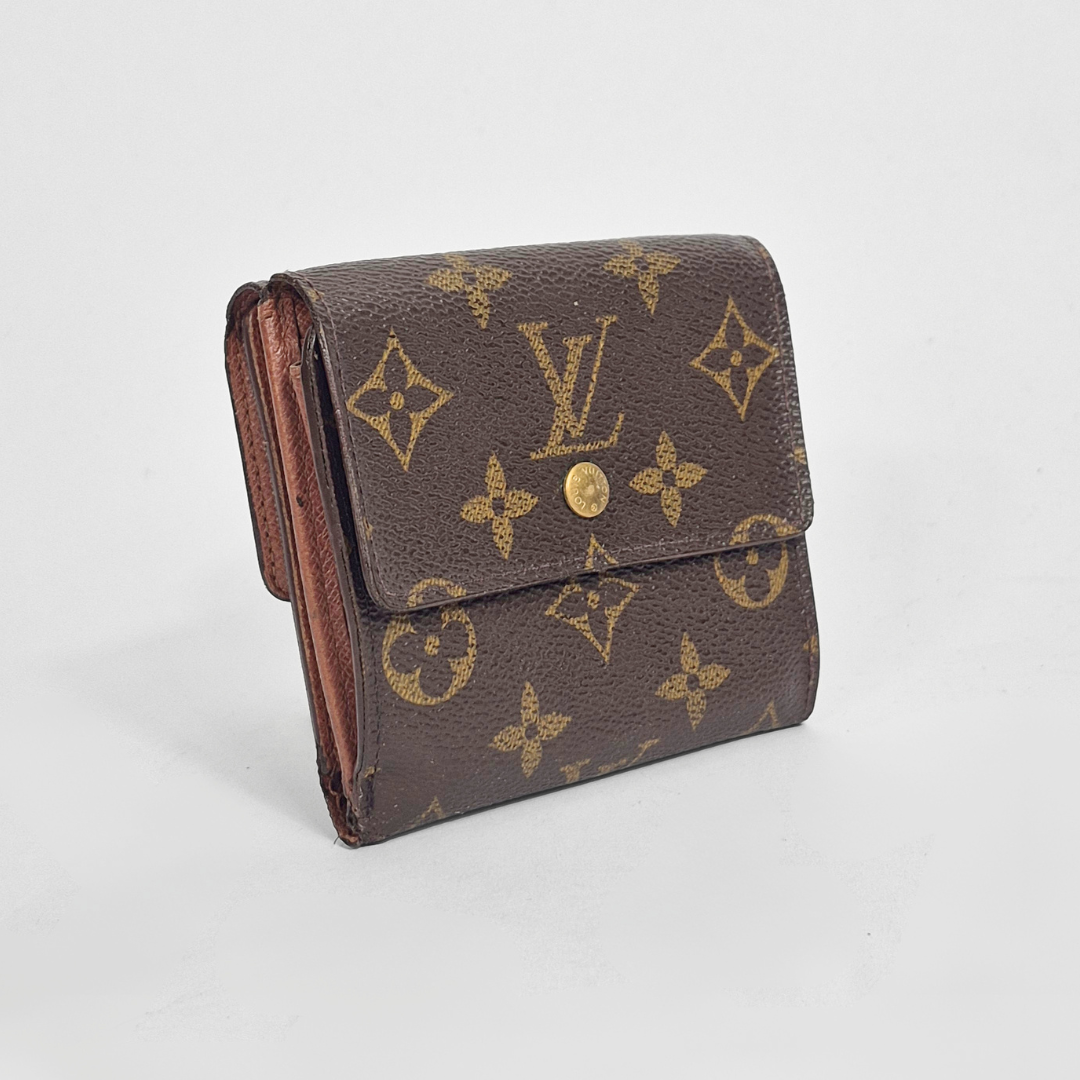 Louis Vuitton wallet with monogram pattern on a light gray background