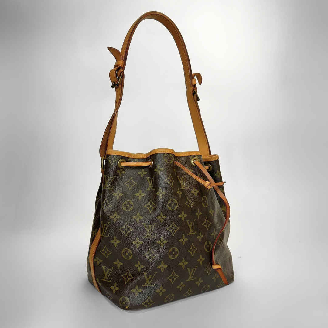 Designer handbag with monogram pattern on a light gray background