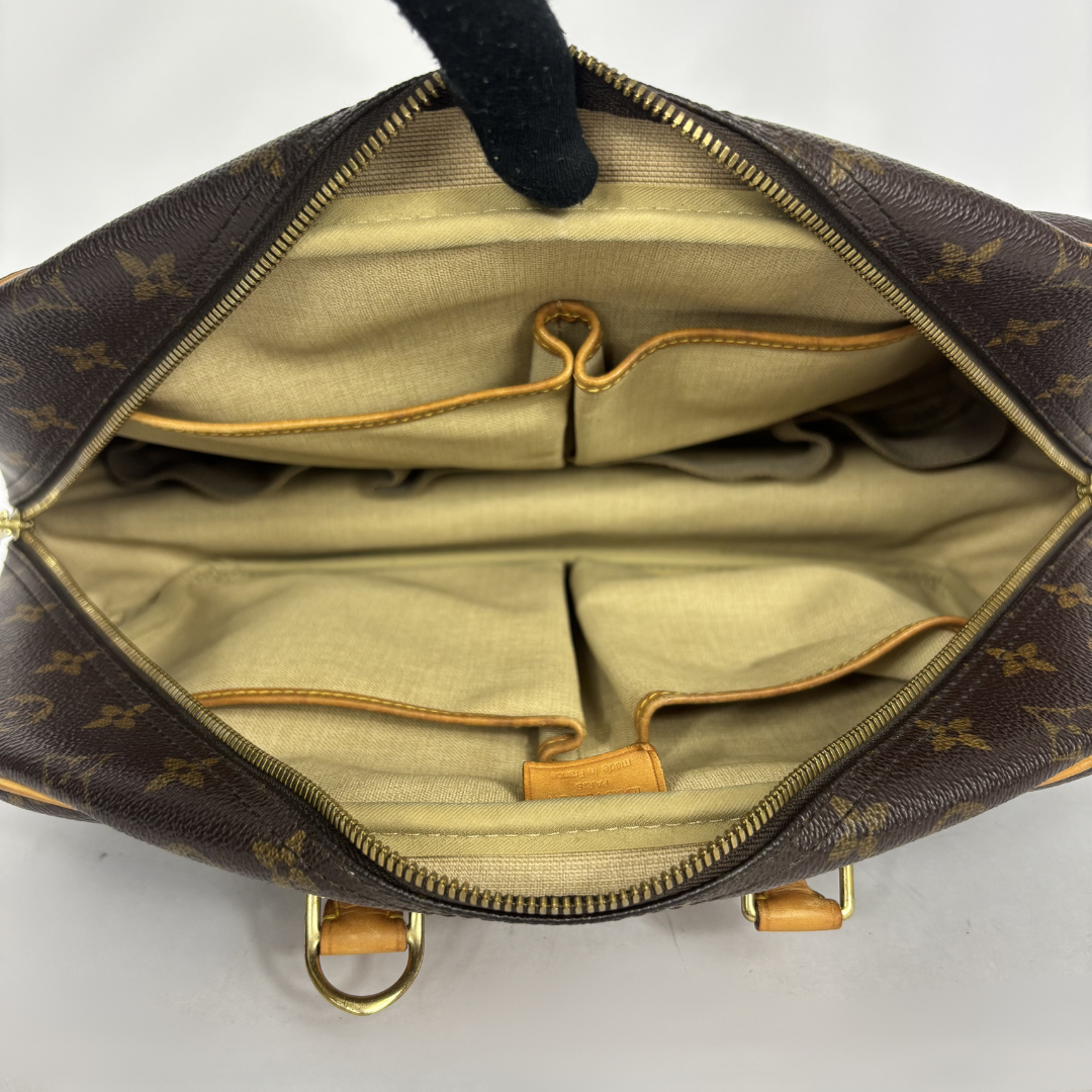 Designer handbag with monogram pattern on a white background