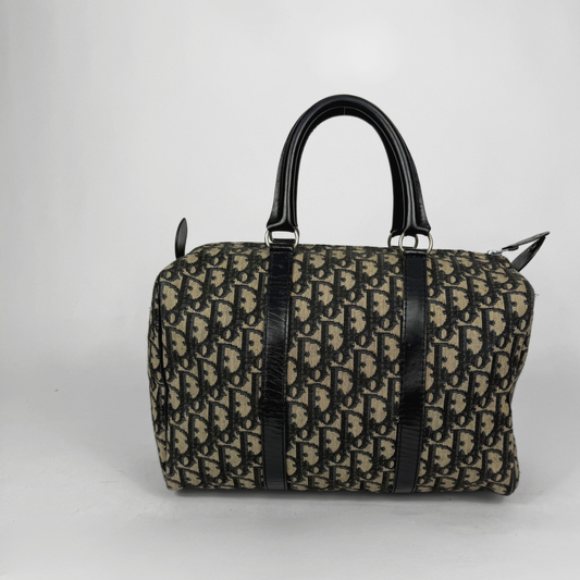 Designer handbag with black and beige pattern on a white background