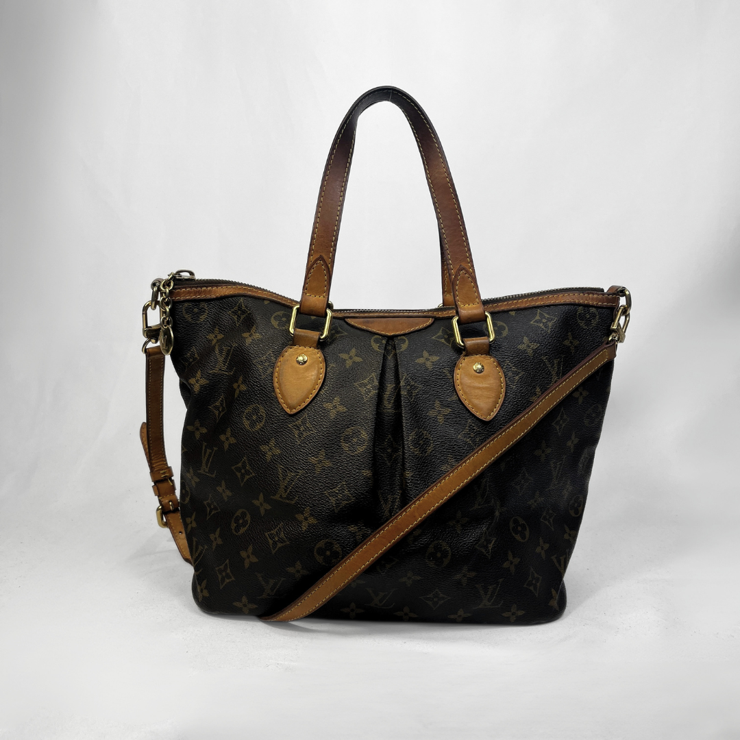 Louis Vuitton monogram canvas shoulder bag with brown leather handles and trim, shown on a white studio background.