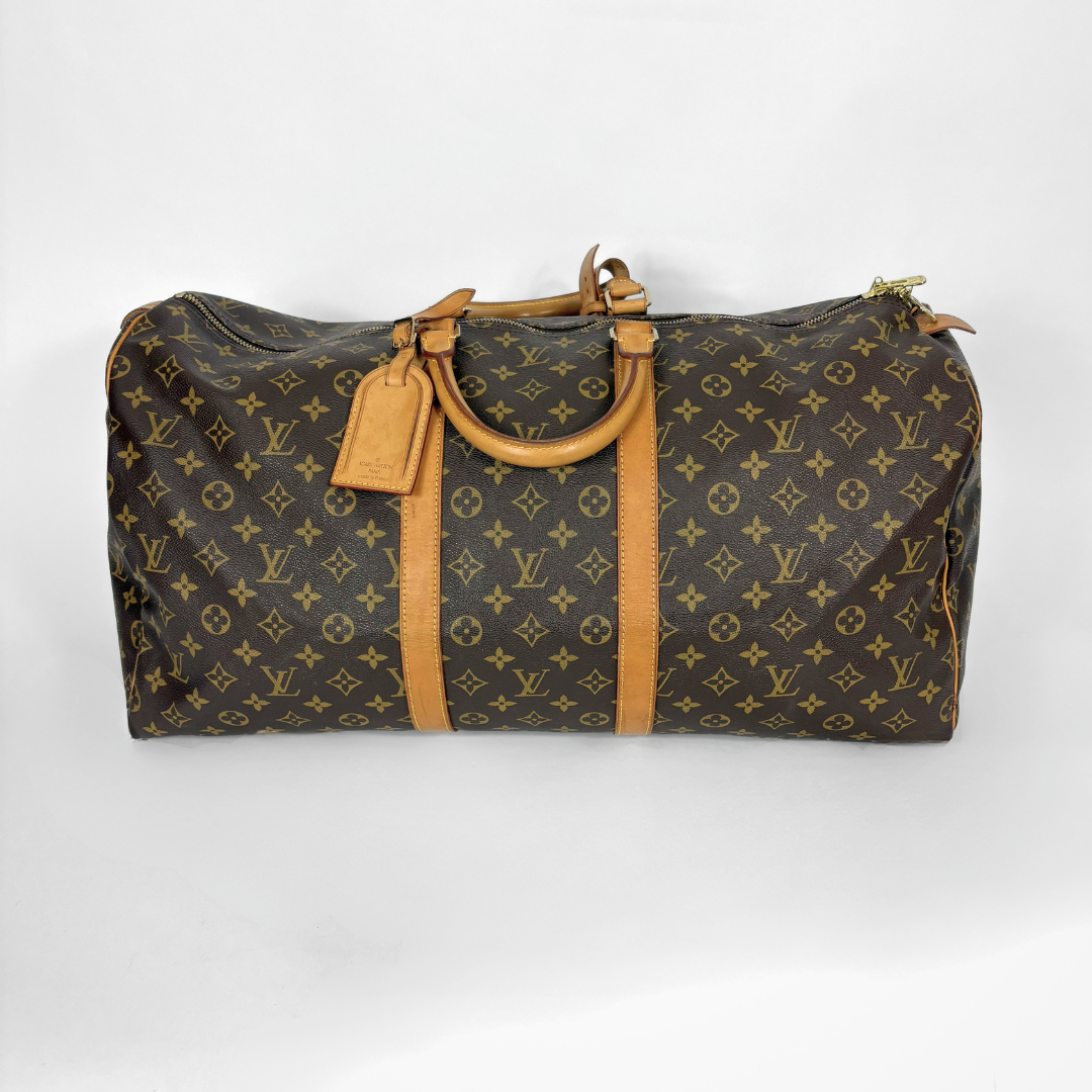 Designer handbag with monogram pattern on a white background