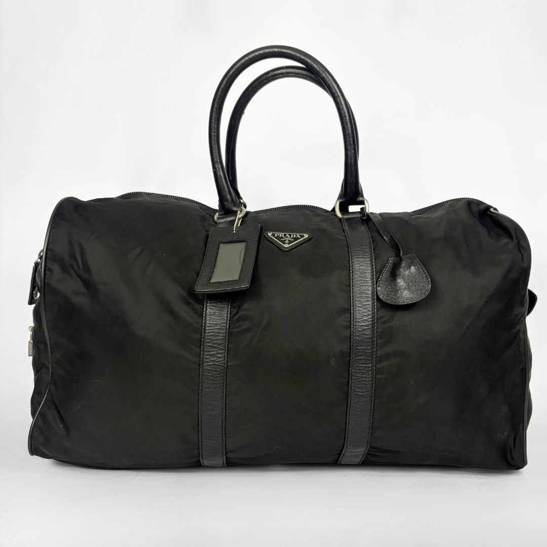 Black backpack with a strap and lock on a white background