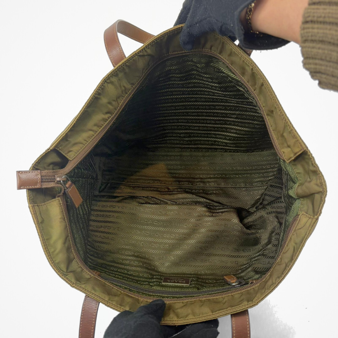 Green backpack with brown leather straps on a white background