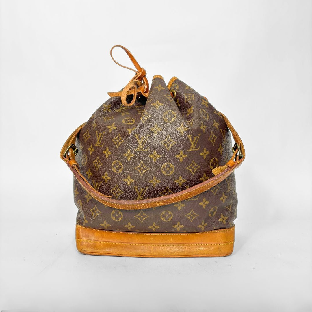 Brown monogram handbag with tan leather accents on a white background