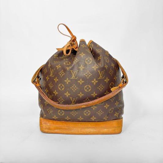 Brown monogram handbag with tan leather accents on a white background