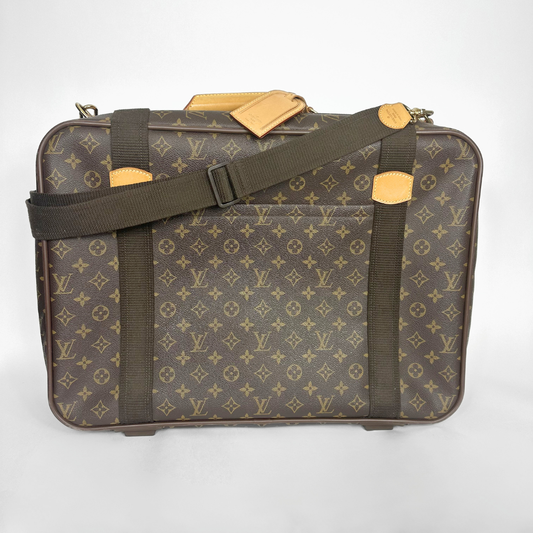 Brown suitcase with gold accents and monogram pattern on a white background