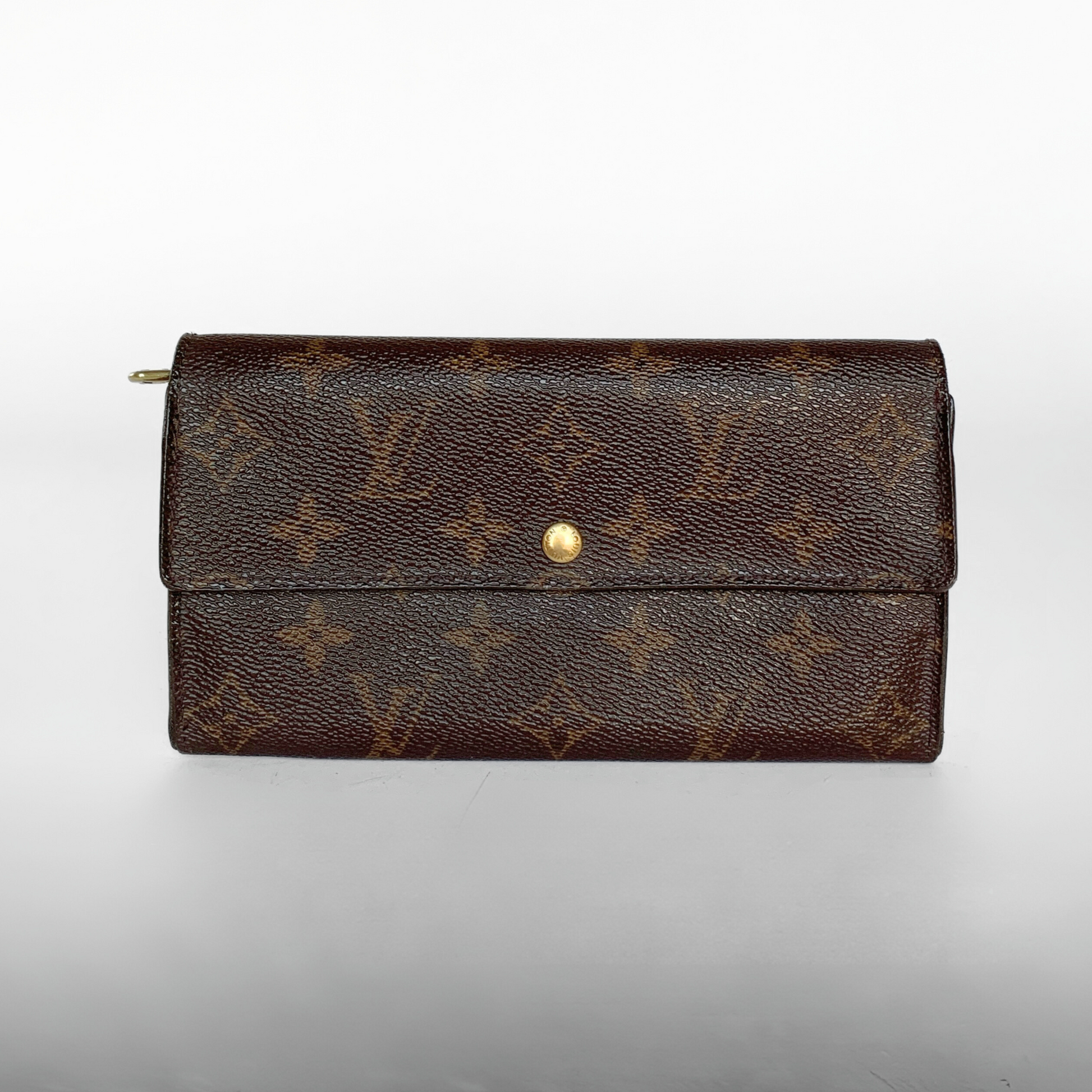A Louis Vuitton monogram canvas long wallet in dark brown with a gold snap button closure, photographed against a neutral light gray background.