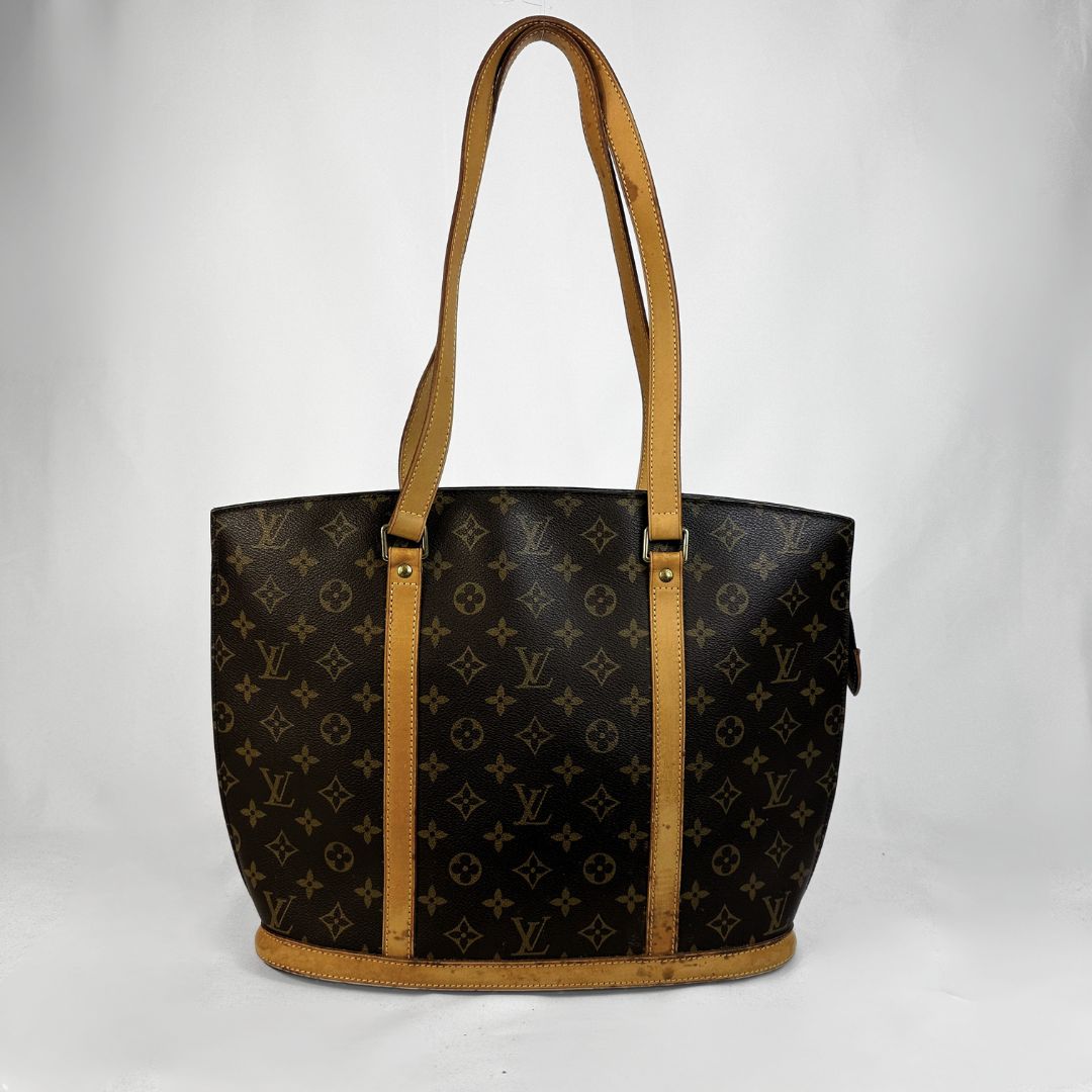 Louis Vuitton monogram canvas Babylon with tan leather shoulder straps and trim, shown against a plain white background.