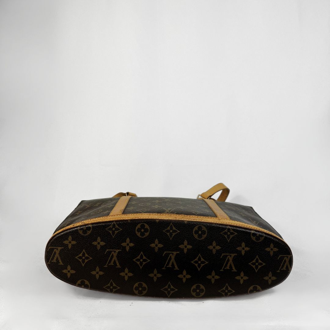 Louis Vuitton monogram canvas Babylon with tan leather shoulder straps and trim, shown against a plain white background.