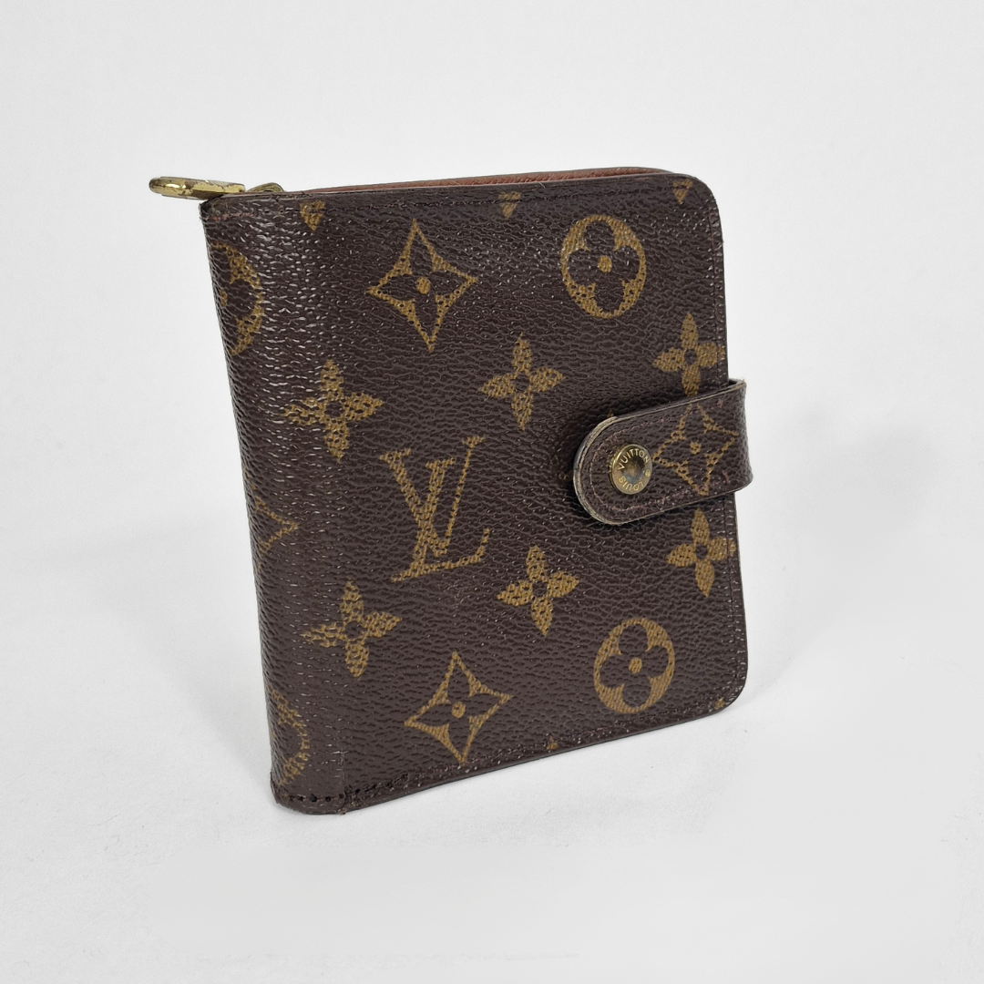 Louis Vuitton wallet with monogram pattern on a white background