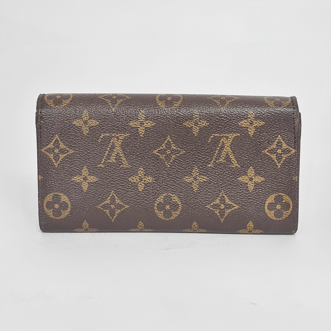 Brown wallet with gold monogram pattern on a white background
