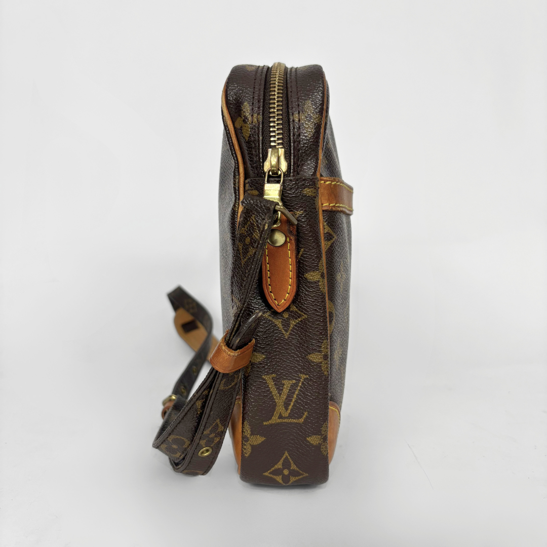 Louis Vuitton monogram handbag with gold zipper on a white background