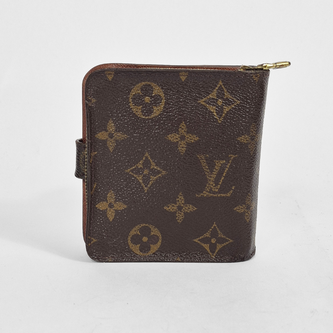 Brown wallet with gold monogram pattern on a white background