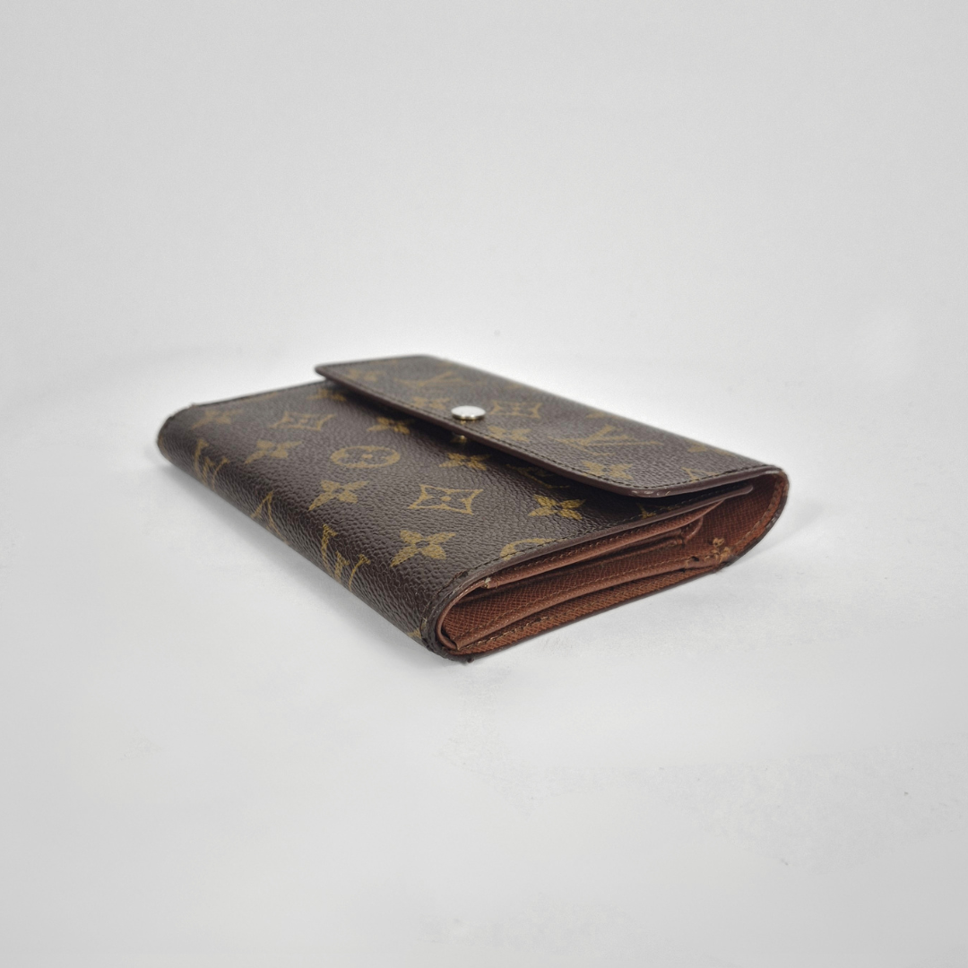 Louis Vuitton wallet with monogram pattern on a white background