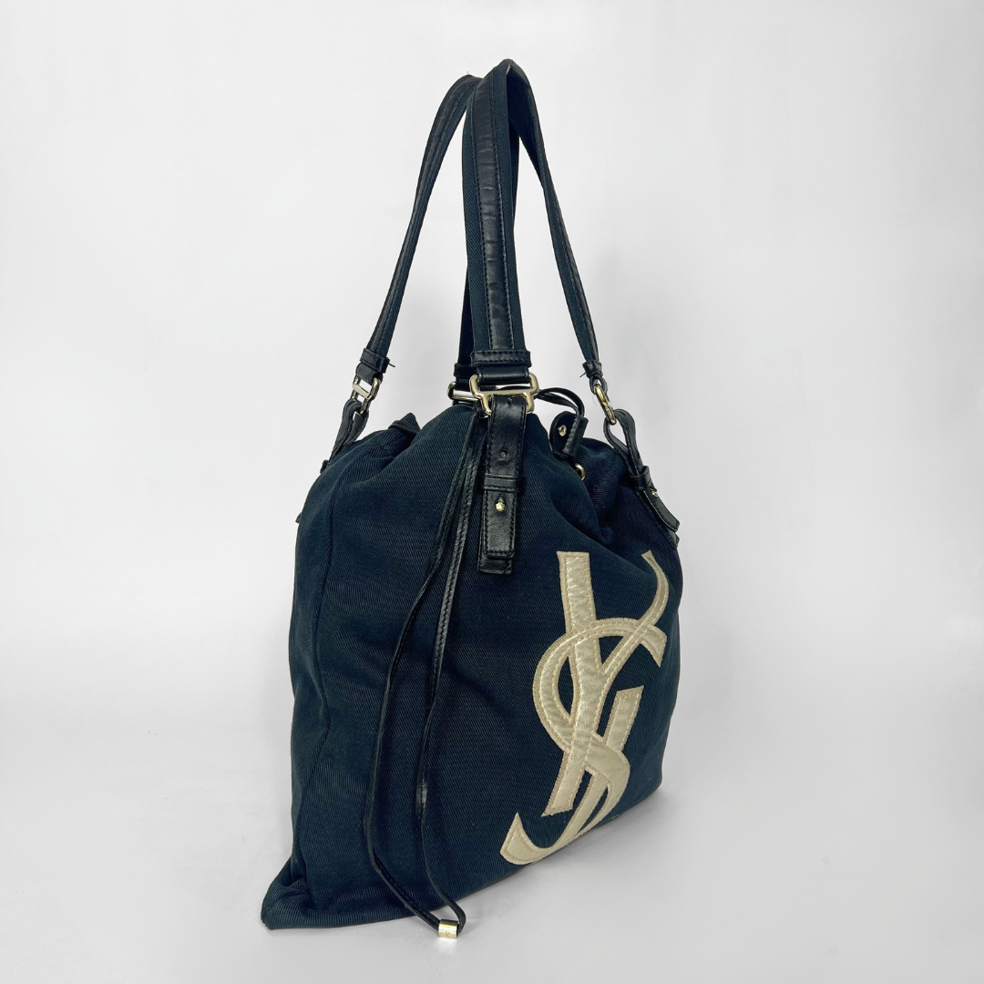 Navy blue totebag with a white logo on a white background