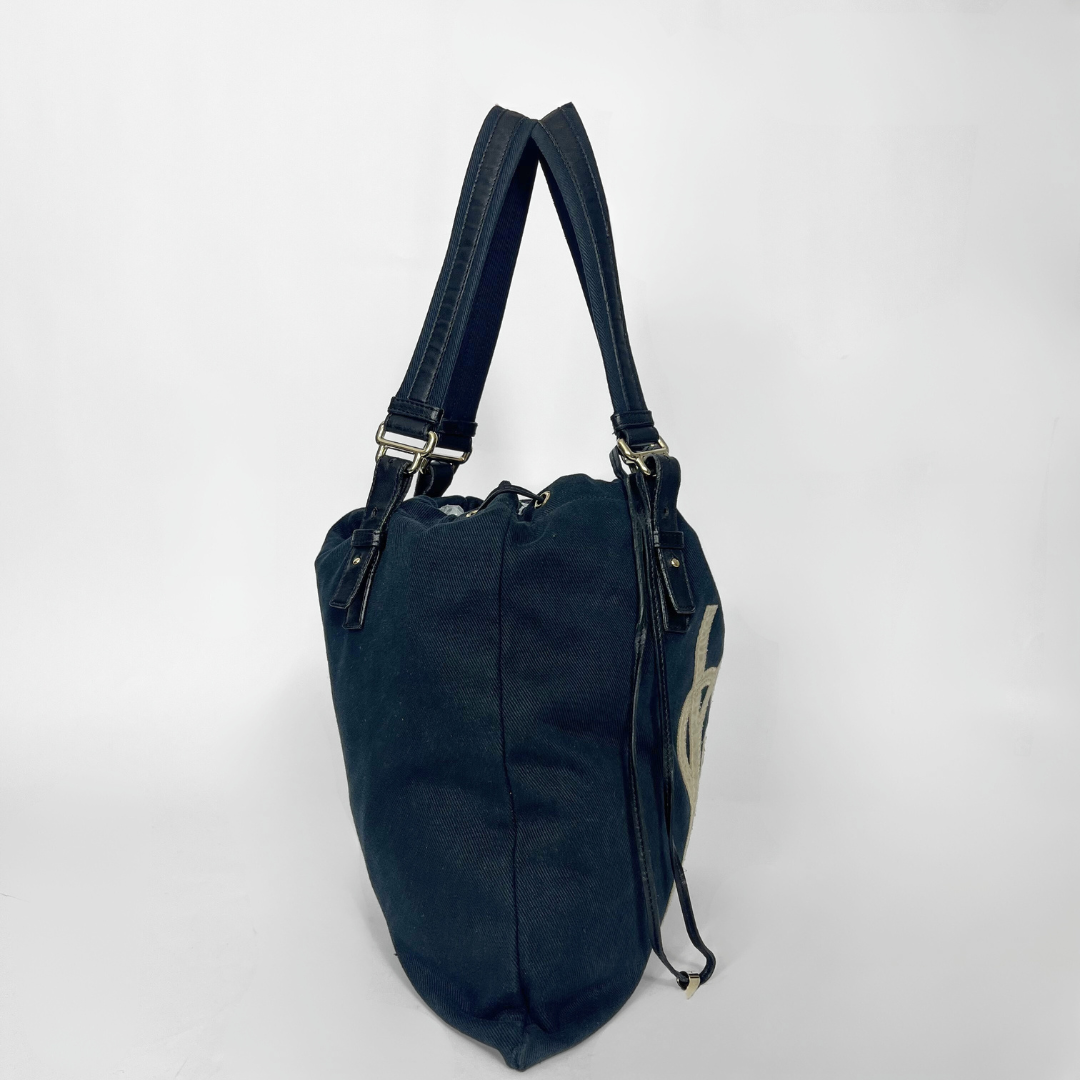 Navy blue handbag with a white logo on a white background