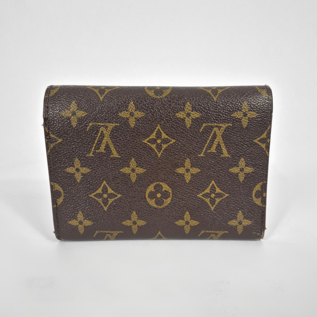 Louis Vuitton wallet with monogram pattern on a white background