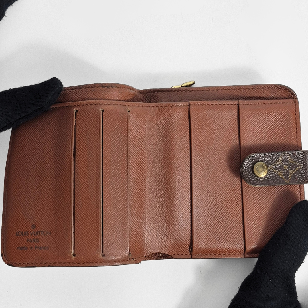 Brown leather wallet with visible brand logo on a white background