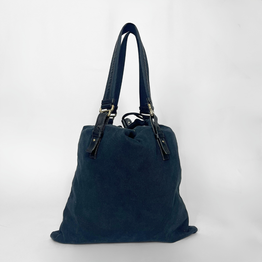 Navy blue handbag with a white logo on a white background