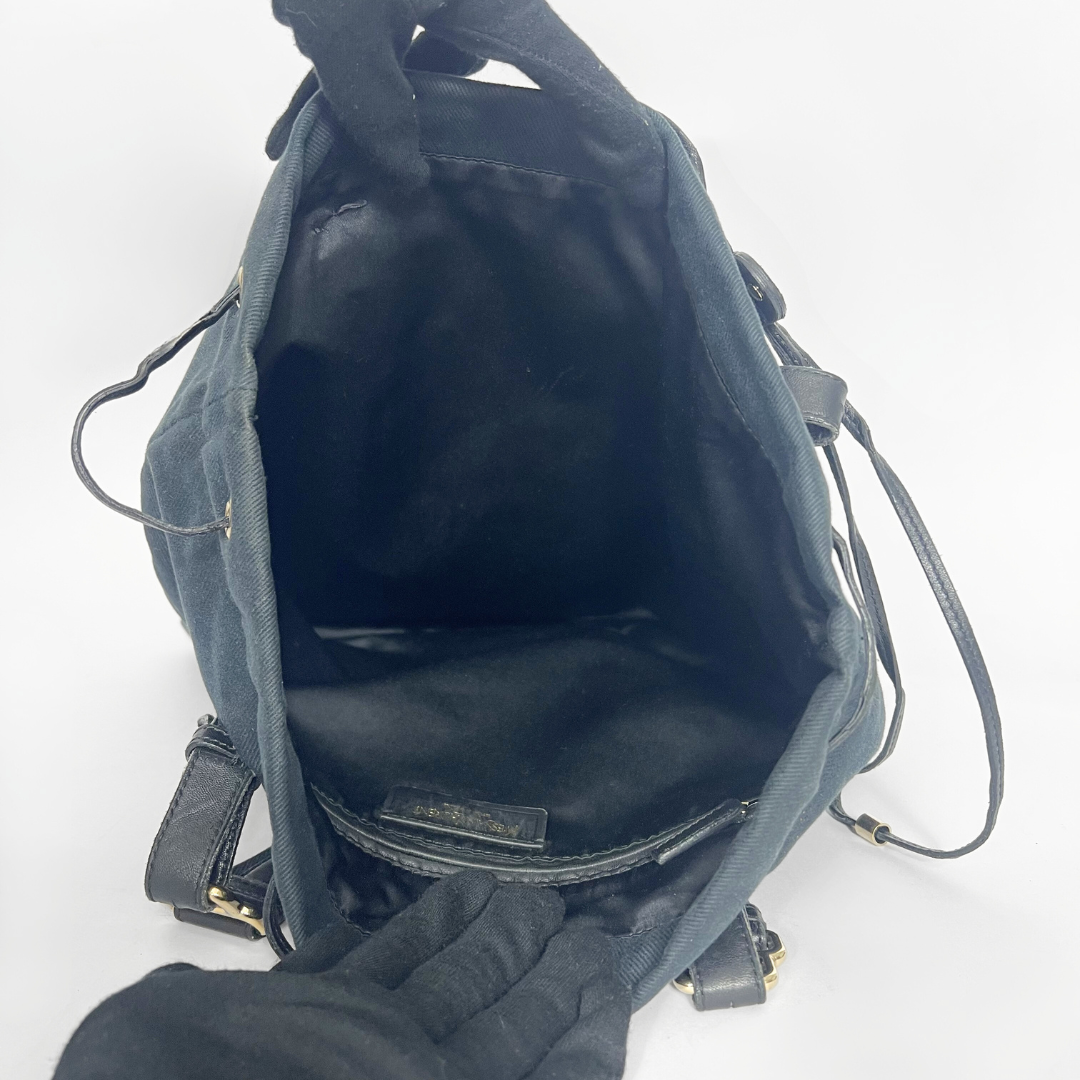 Navy blue handbag with a white logo on a white background