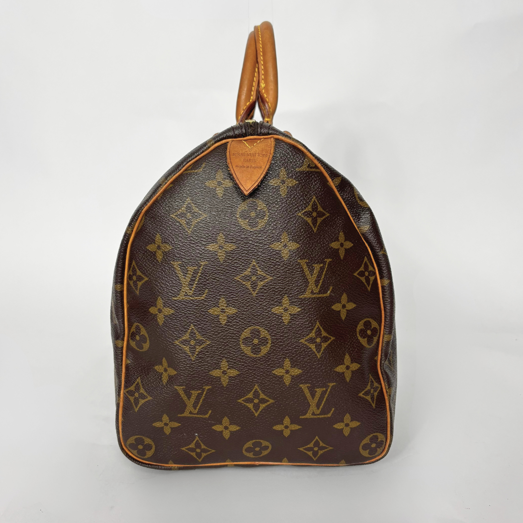 Brown handbag with monogram pattern on a white background