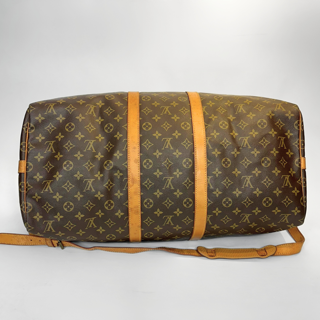 Brown duffel bag with monogram pattern on a white background