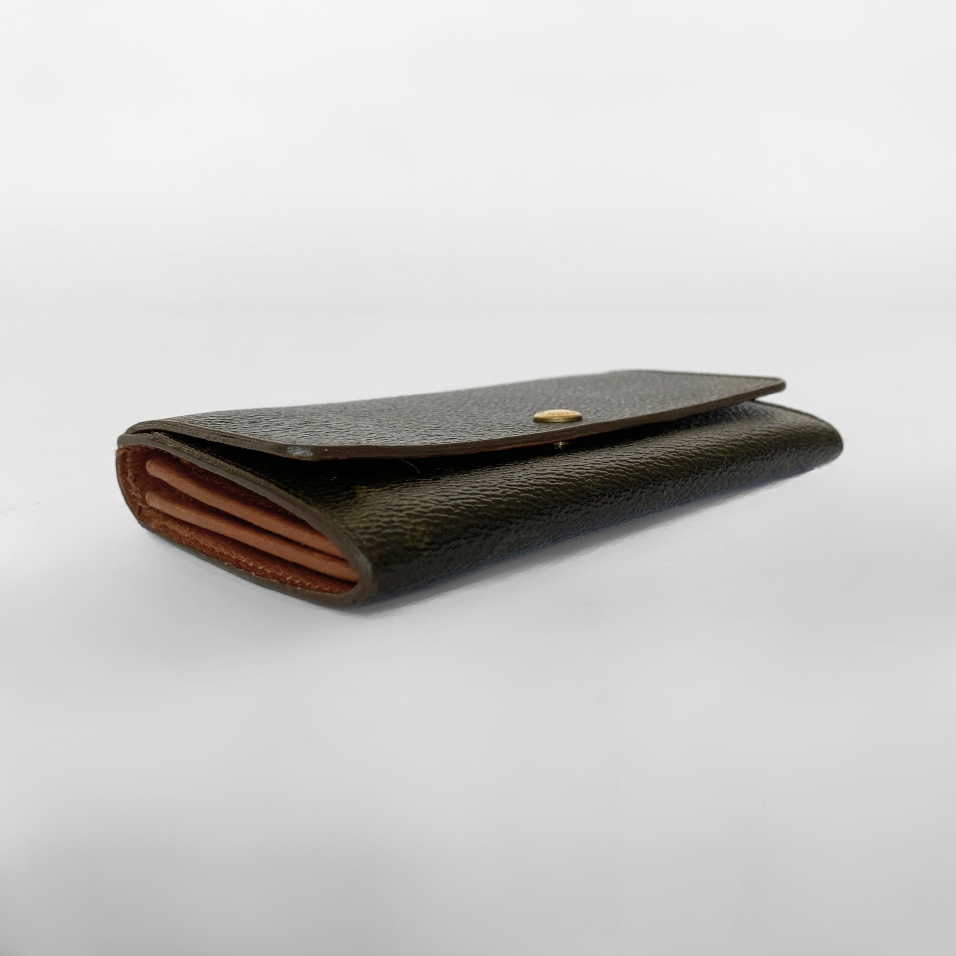 Black leather wallet with a gold button on a white background