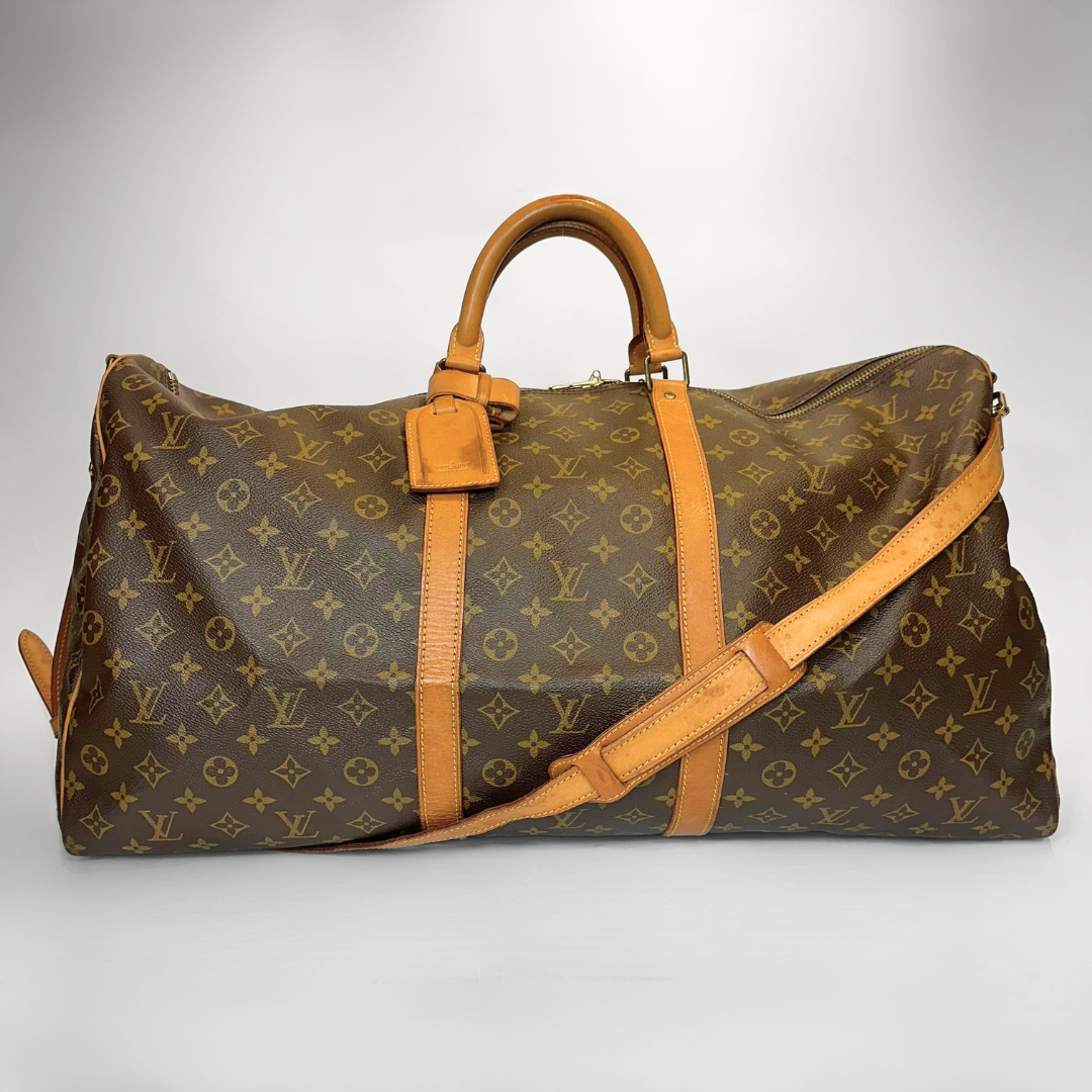 Louis Vuitton monogram duffel bag with brown leather straps on a light gray background
