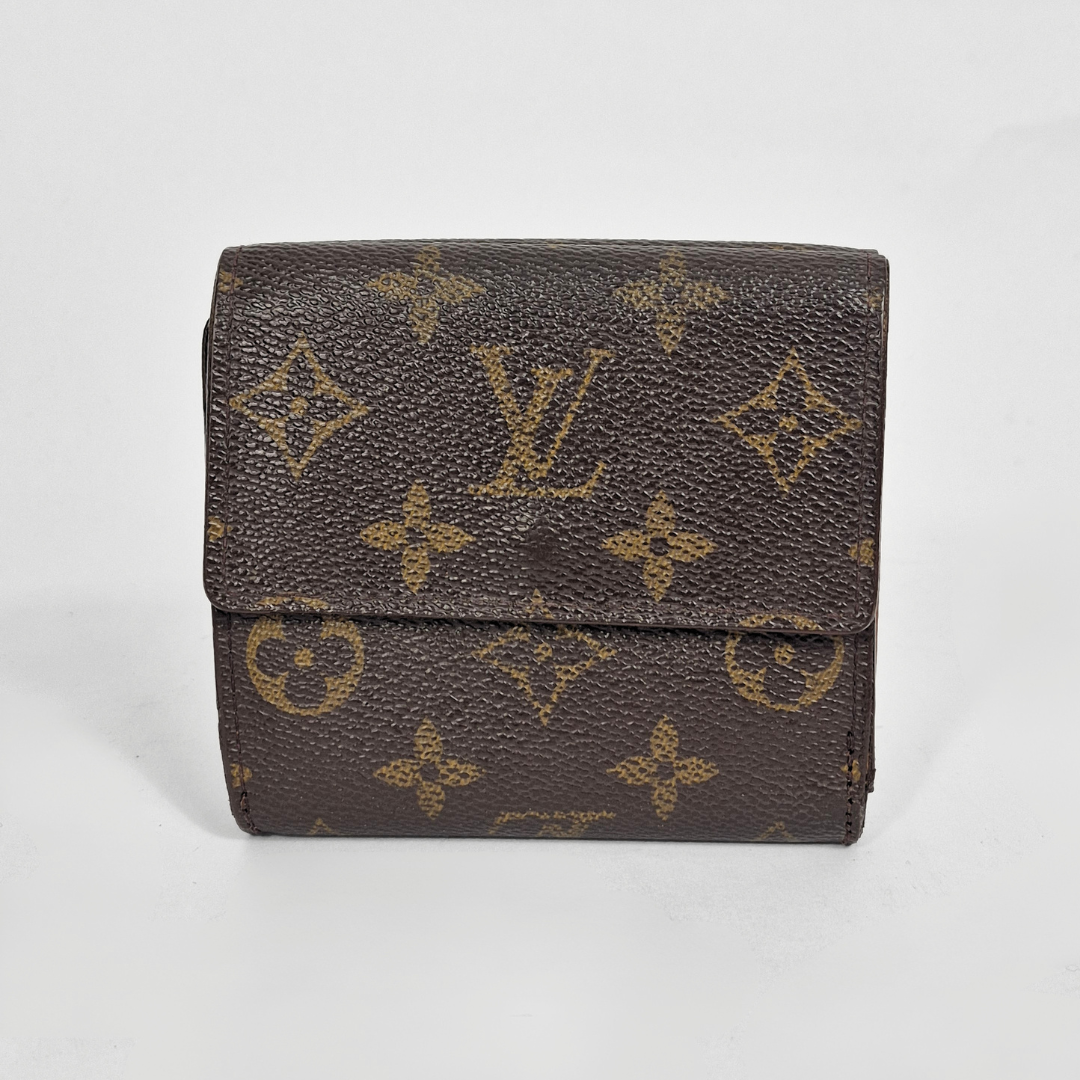 Louis Vuitton wallet with monogram pattern on a light gray background