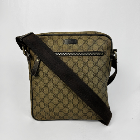 A vintage Gucci crossbody bag in brown GG Supreme canvas with a black strap, shown on a white background.