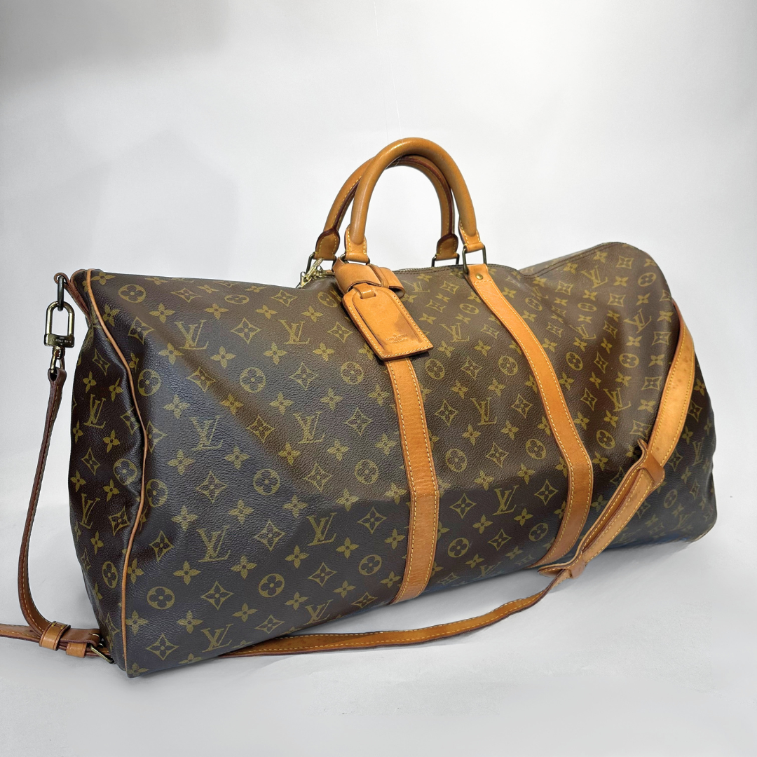 Louis Vuitton monogram duffel bag with brown straps on a white background
