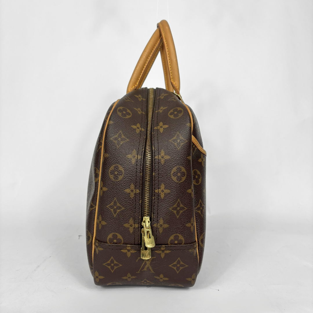 Designer handbag with monogram pattern on a white background