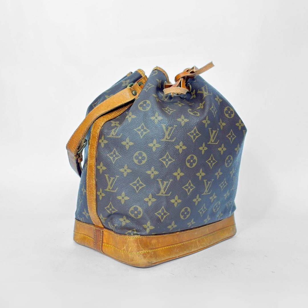 Brown monogram handbag with brown leather accents on a white background