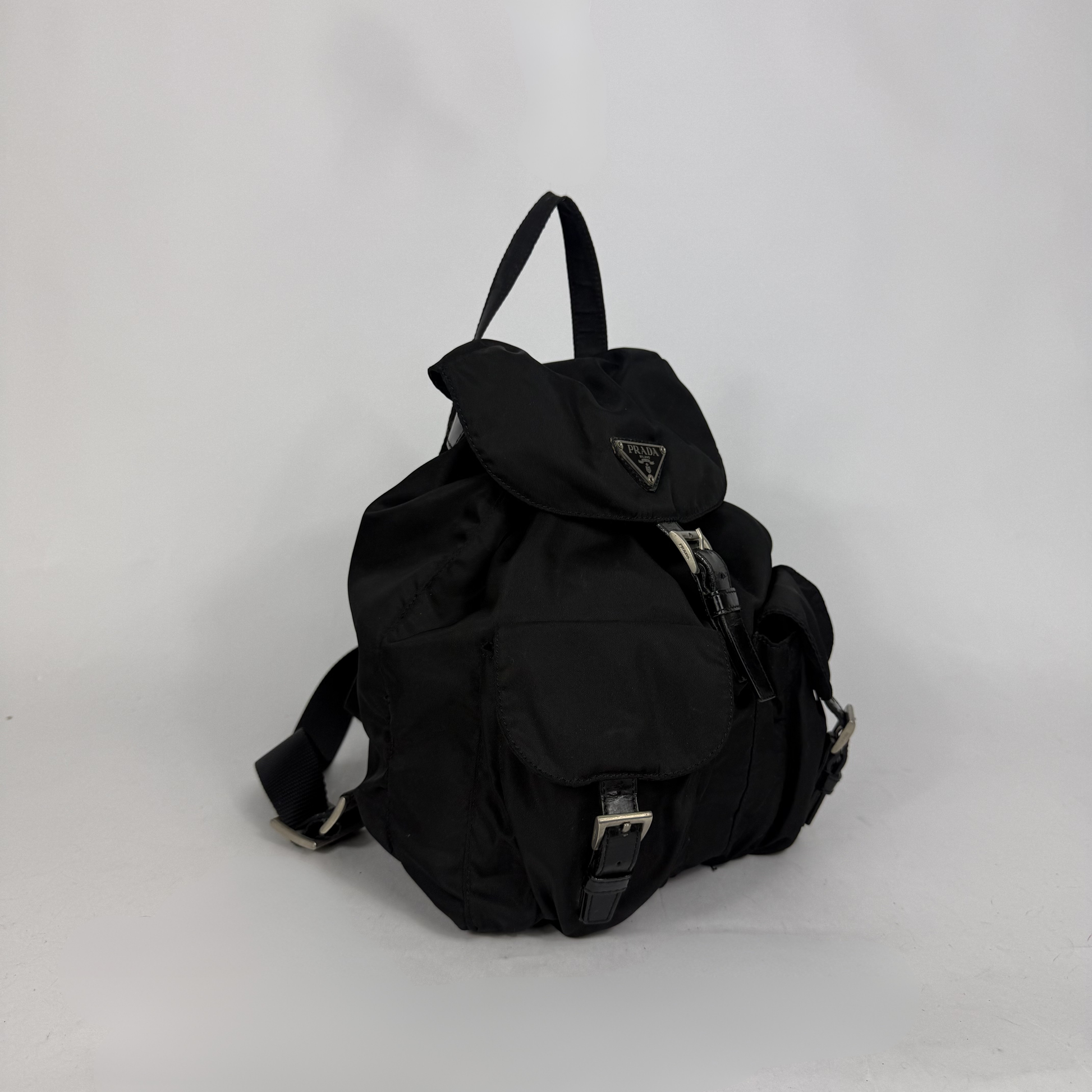 Black backpack with a brand logo on a white background