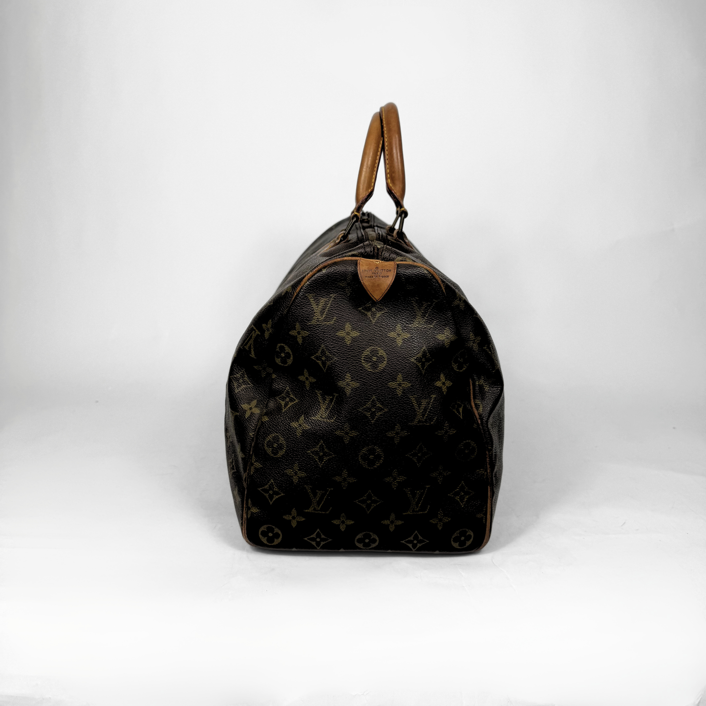 Designer handbag with monogram pattern on a white background