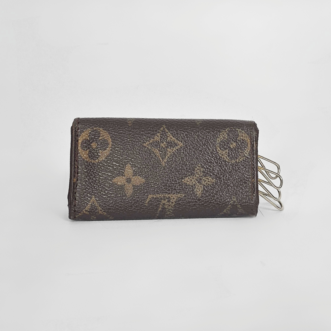 Brown wallet with monogram pattern on a light gray background