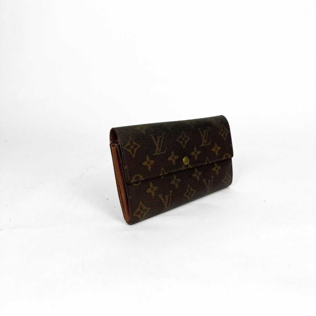 Brown wallet with monogram pattern on a white background